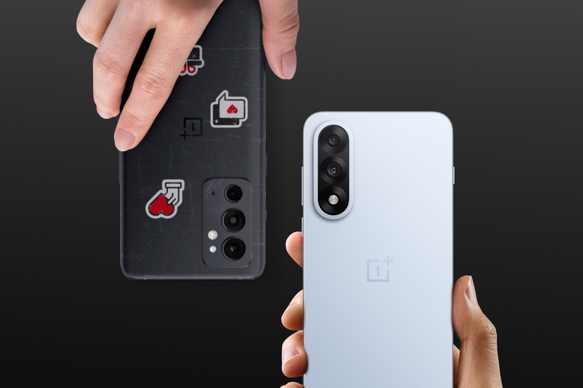 Two people exchanging a black mobile device and a red box on a wooden floor.