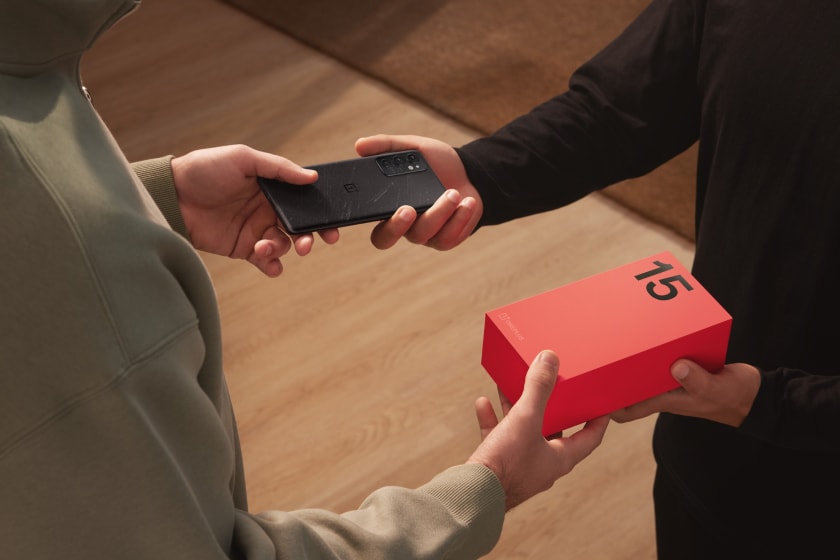 Black smartphone and red box in hands
